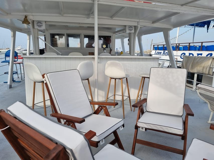 Rhodes: Sunset Cruise with Live Music, Wine & Greek Buffet - Leaving Mandraki Port with Rhodes behind you